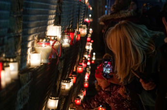 Латвийцы несут памятные свечи к стене Рижского замка в День Лачплесиса, 11 ноября 2020