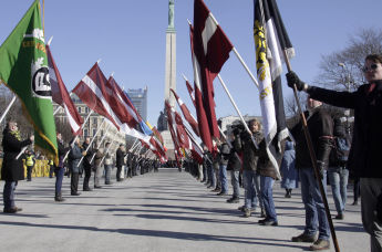 Представители радикальных националистических организаций встречают ветеранов латышского легиона СС во время их марша к памятнику Свободы в Риге