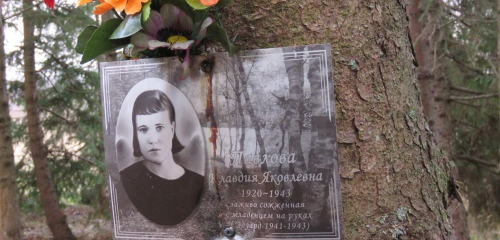 Фотография сожженной вместе с младенцем Клавдии Павловой. На дереве возле монумента на месте бывшей деревни Красуха.
