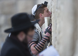 Молящиеся у стены плача в Иерусалиме.