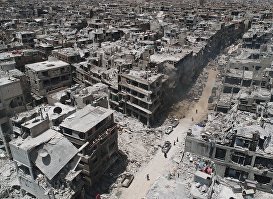 Разрушенные дома на территории бывшего лагеря палестинских беженцев "Ярмук" в Сирии