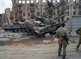 Чеченский конфликт 1994-1996 годов. Солдаты федеральных войск РФ у разбитых танков в разрушенном после штурма Грозном.