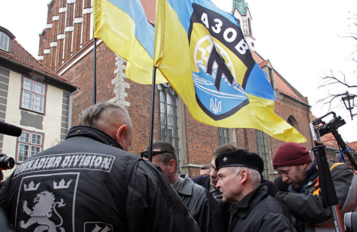 Люди с флагами украинского националистического добровольческого батальона "Азов" участвуют в шествии латышского легиона Ваффен СС в Риге,16 марта 2016 года