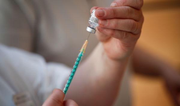 Медицинский работник готовит дозу вакцины Pfizer-BioNTech в центре вакцинации от коронавируса 
